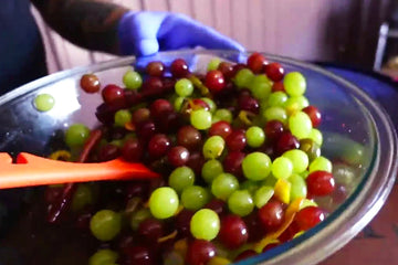 a bowl of multi-colored grapes in a bowl.