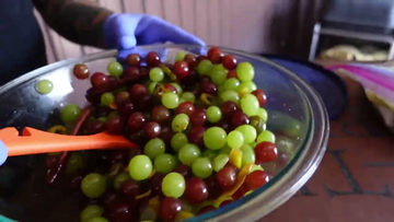 a bowl of multi-colored grapes in a bowl.