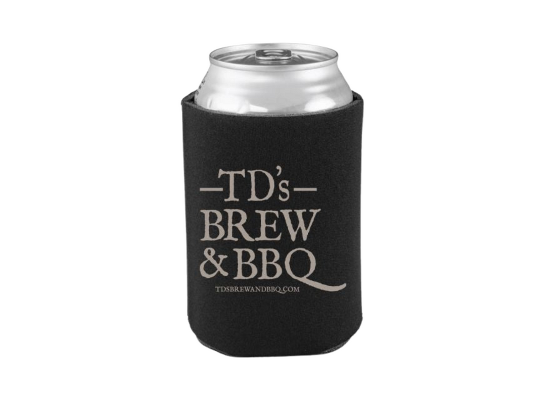 Black can cooler with 'TD's Brew & BBQ' text on a wooden surface and background