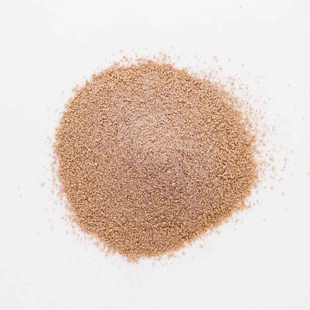 Bottle of TDs Brew & BBQ Barrel Aged Bourbon Rub on a wood plank with wood background.