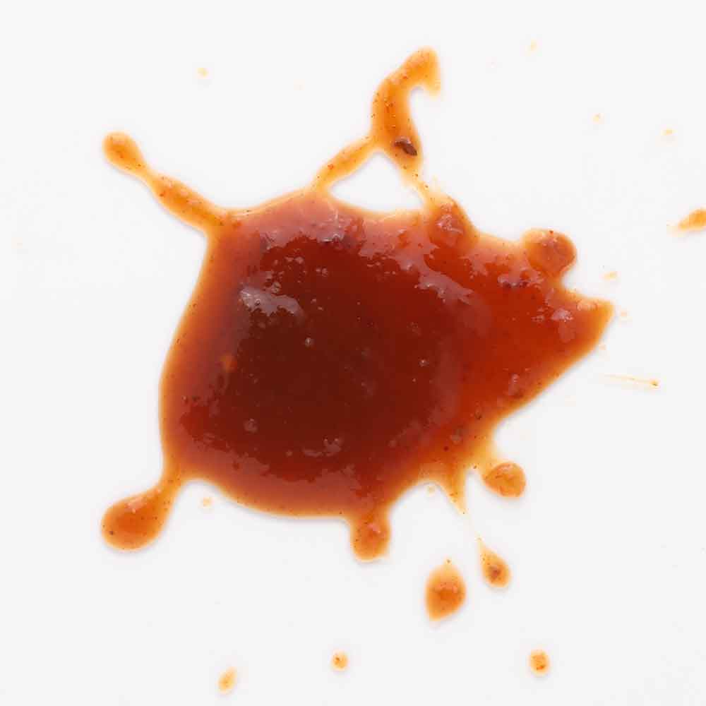 TDs Brew and BBQ Atomic Pineapple BBQ Sauce splatter on white background