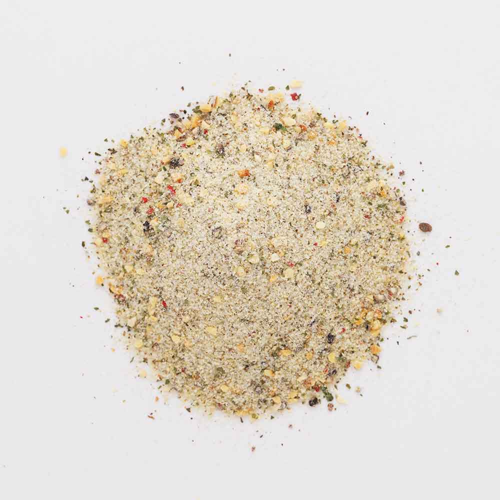 Jar of TD's Brew & BBQ Carne Sutra spice blend on a wooden surface with a wooden background