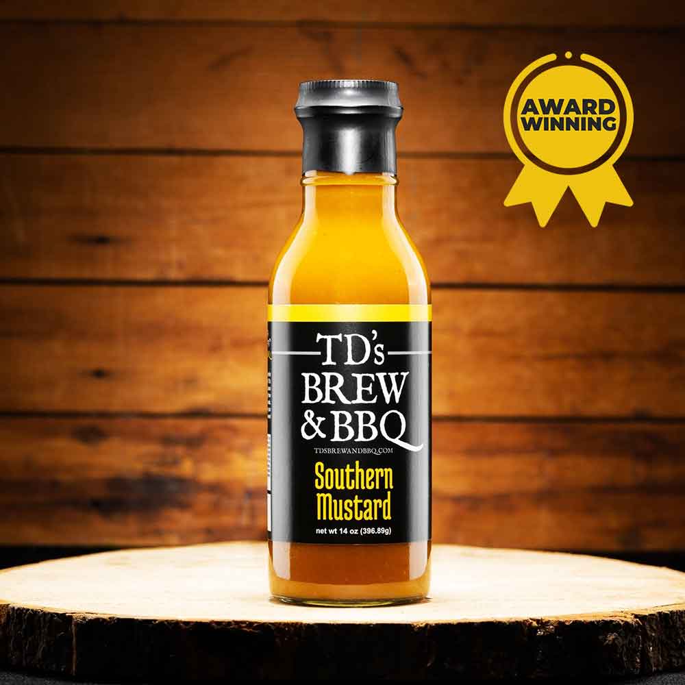 Bottle of TD's Brew & BBQ Southern Mustard on a wooden surface with an award badge.