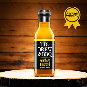 Bottle of TD's Brew & BBQ Southern Mustard on a wooden surface with an award badge.