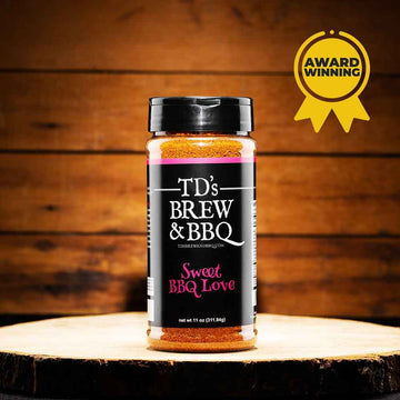 Jar of TD's Brew & BBQ Sweet BBQ Love seasoning on a wooden surface with an award badge.