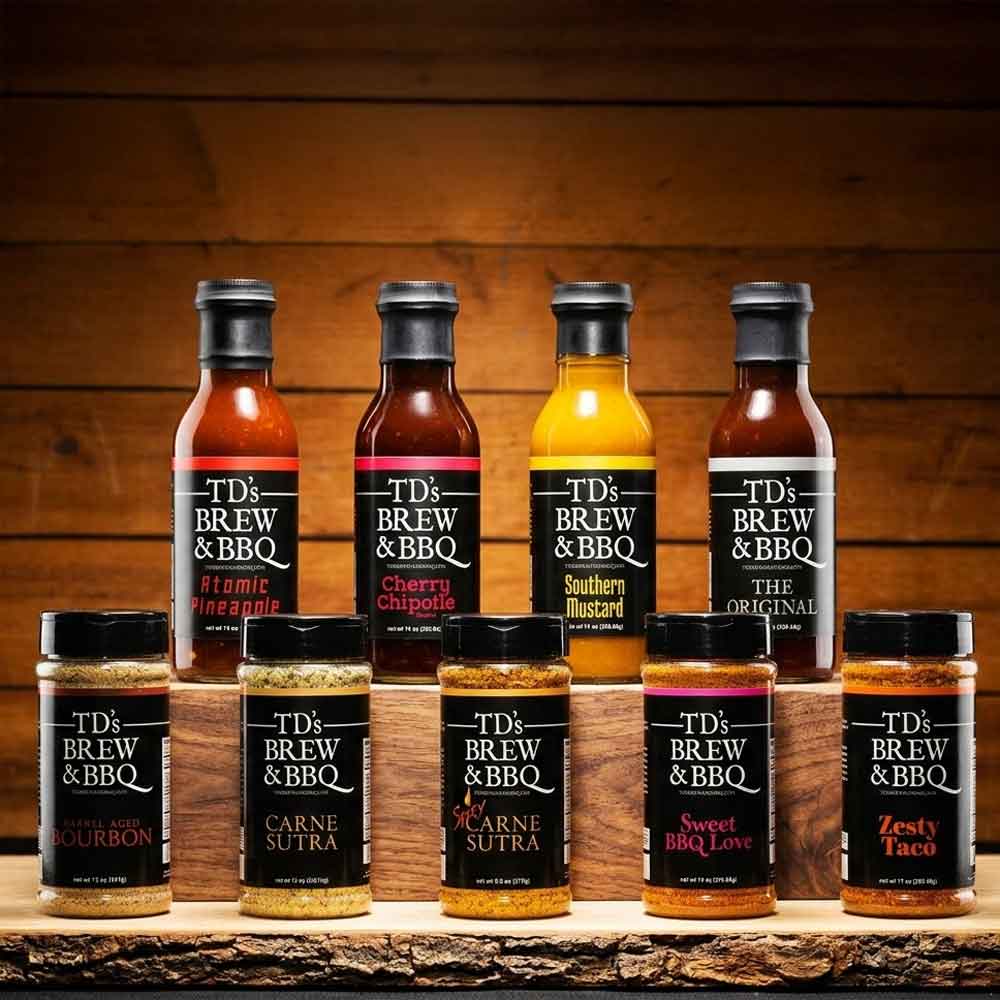Collection of TD's Brew & BBQ products on a wooden surface with a wooden background.