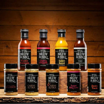 Collection of TD's Brew & BBQ products on a wooden surface with a wooden background.